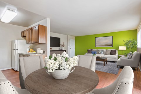 a living room and dining room with a table with flowers