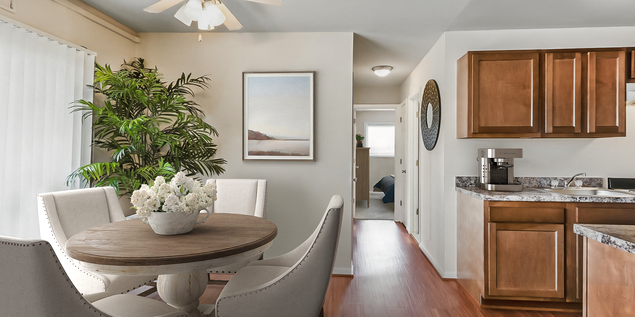 a kitchen and dining room with a table and chairs