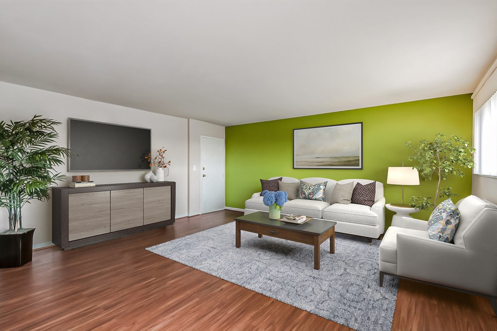 a living room with a green wall and a couch and a table