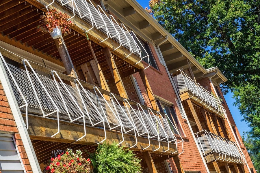 an old brick building with a balcony with metal railings