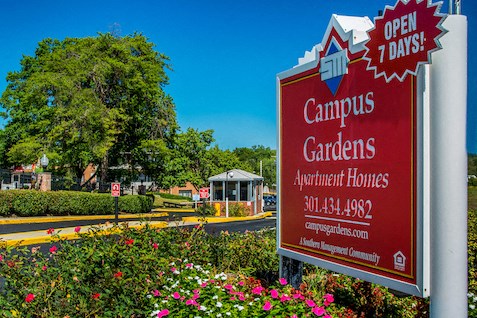 a sign for a campus gardeners apartment homes