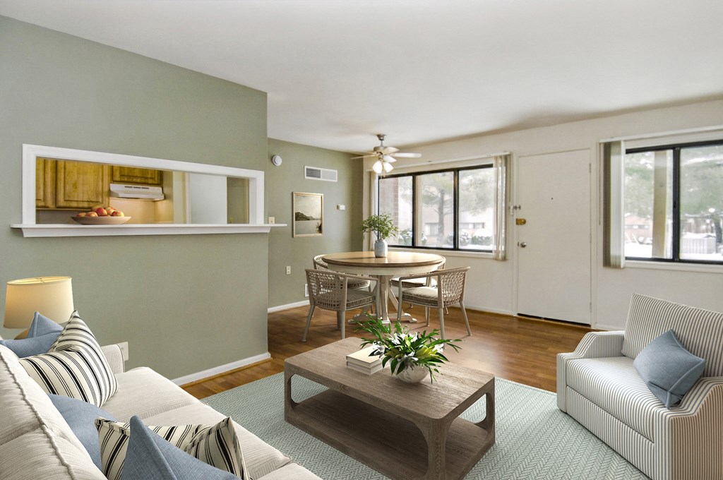 a living room with a couch and a table and a kitchen