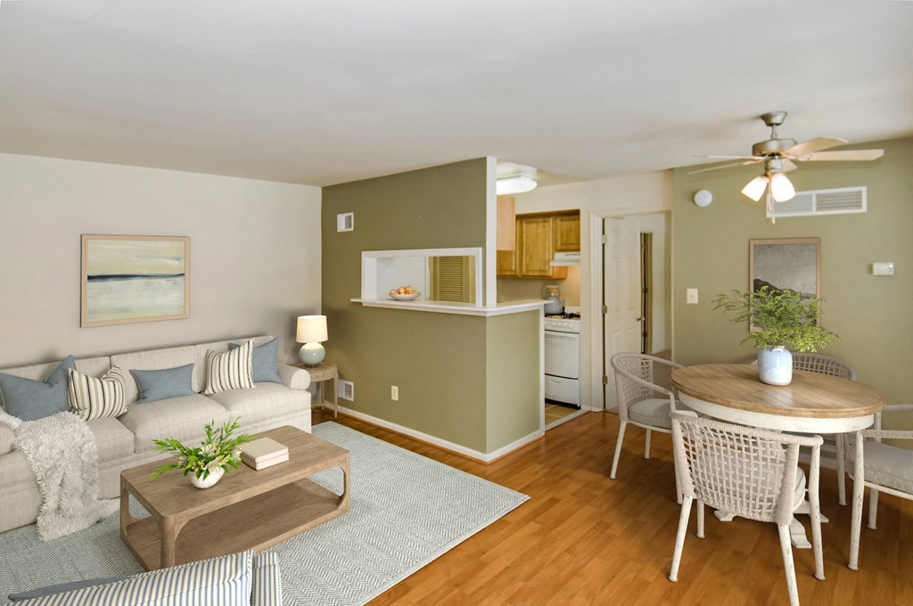 a living room with a couch and a table and a kitchen