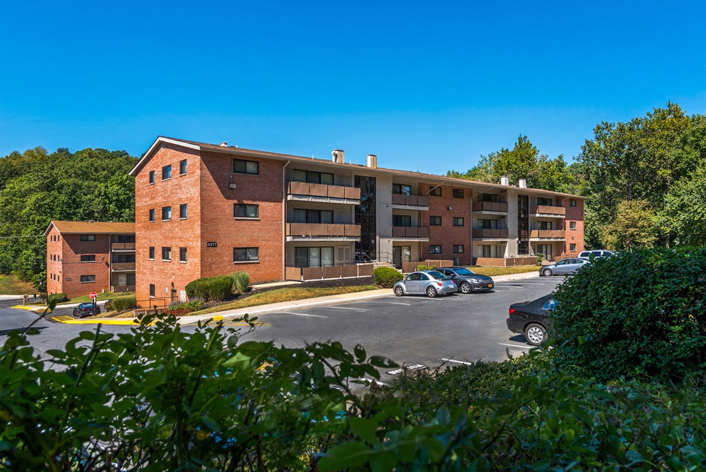 a large brick building with cars parked in front of it