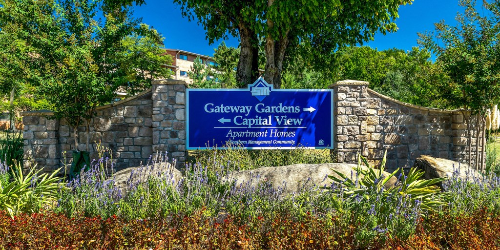 a sign for gateway gardens capital view on a stone wall