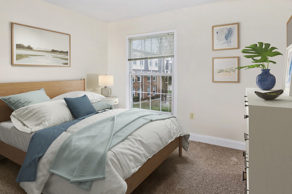 a bedroom with a bed and a large window