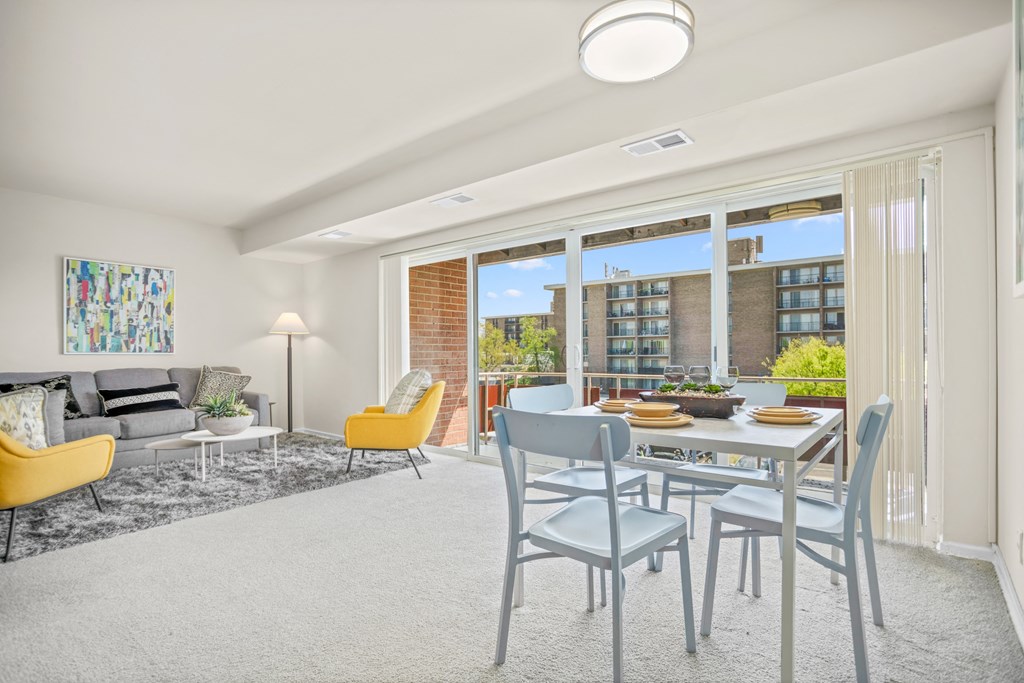 an open living room and dining room with a table and chairs