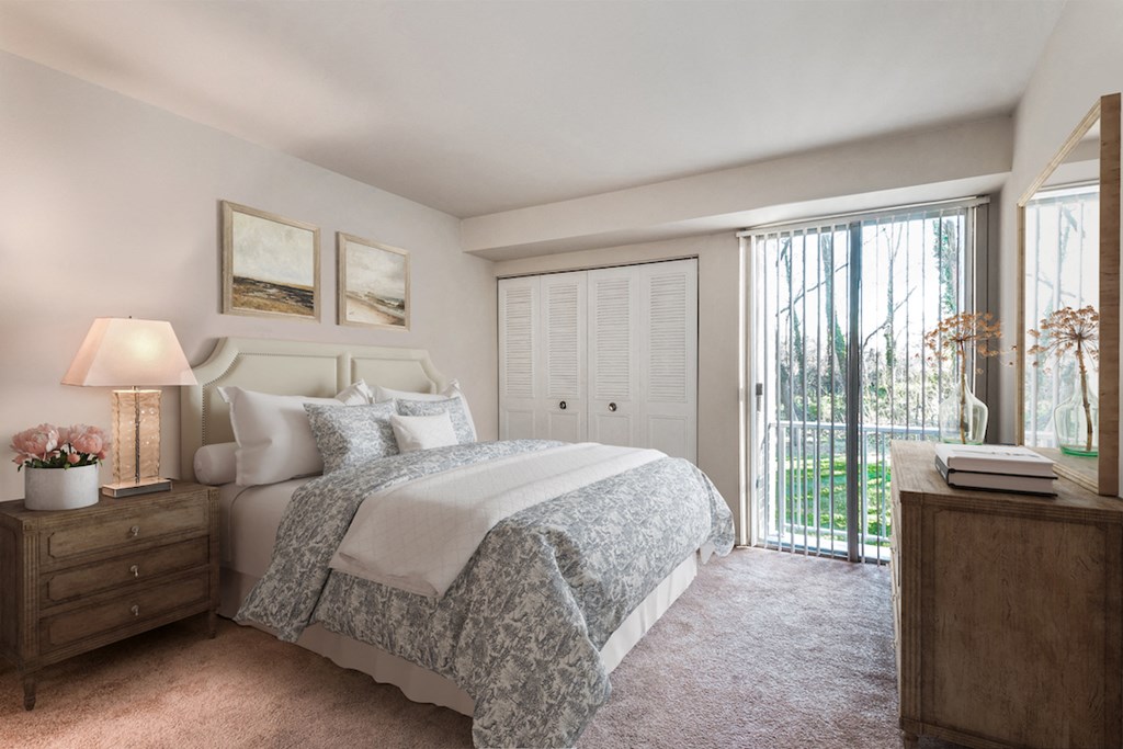 a bedroom with a bed and a door to a balcony