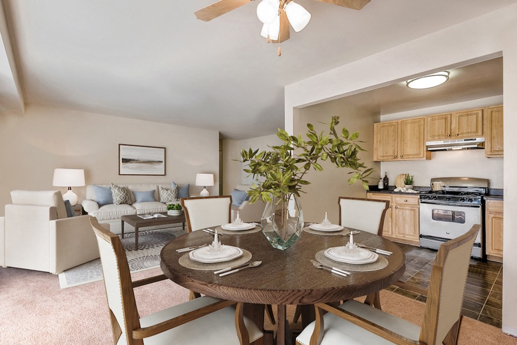 an open living room and dining room with a table and chairs