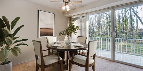 a dining room with a table and chairs and a sliding glass door