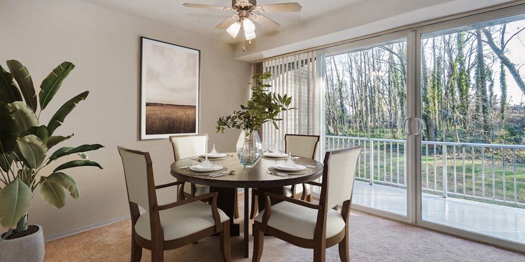 a dining room with a table and chairs and a sliding glass door