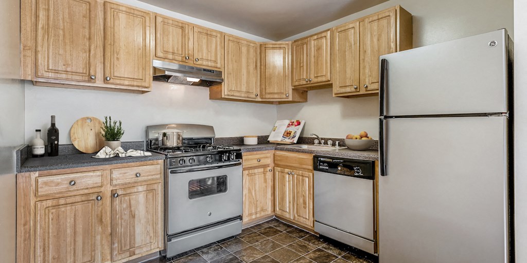 a kitchen with white appliances and wooden cabinets