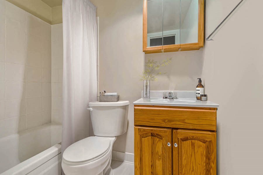 a bathroom with a toilet and a sink and a mirror