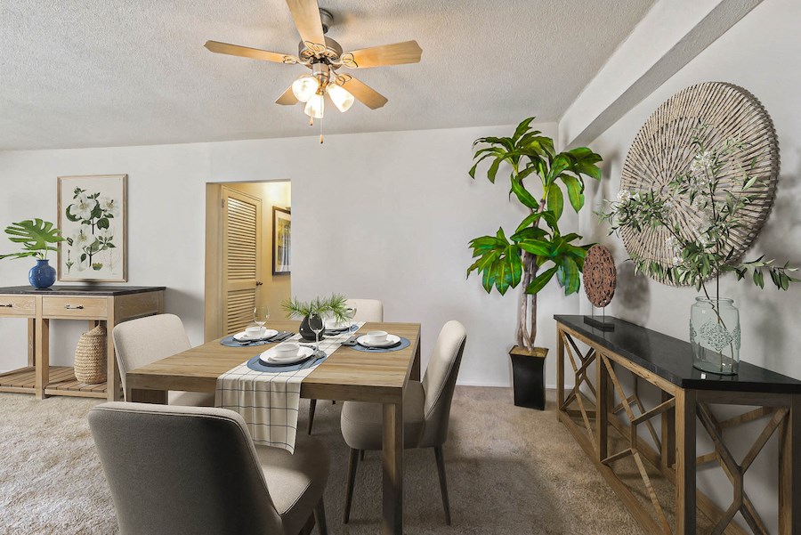 a dining room with a table and chairs and a ceiling fan