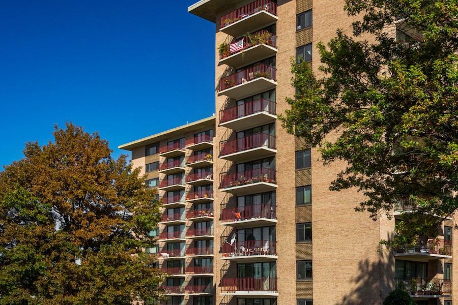 an apartment building with many balconies and trees