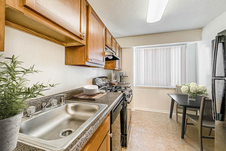 a kitchen with a sink and a stove and a window