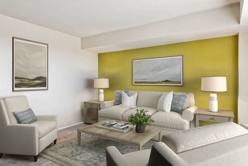 a living room with a yellow wall and white furniture