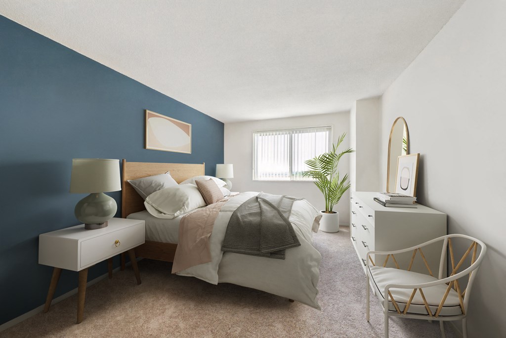 a bedroom with a bed and a blue accent wall