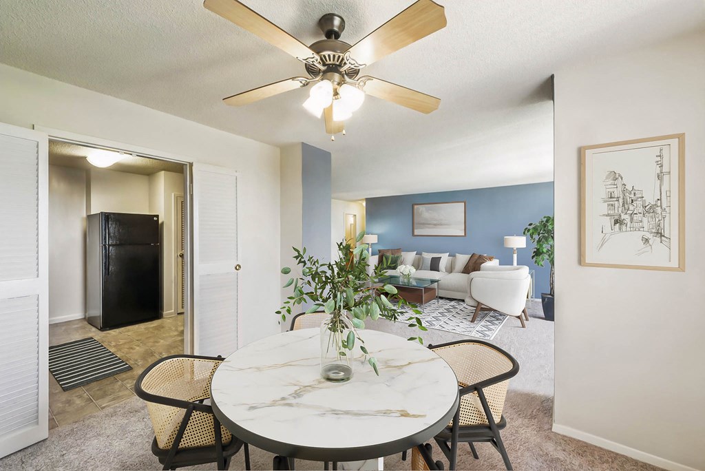 a dining room with a table and a ceiling fan