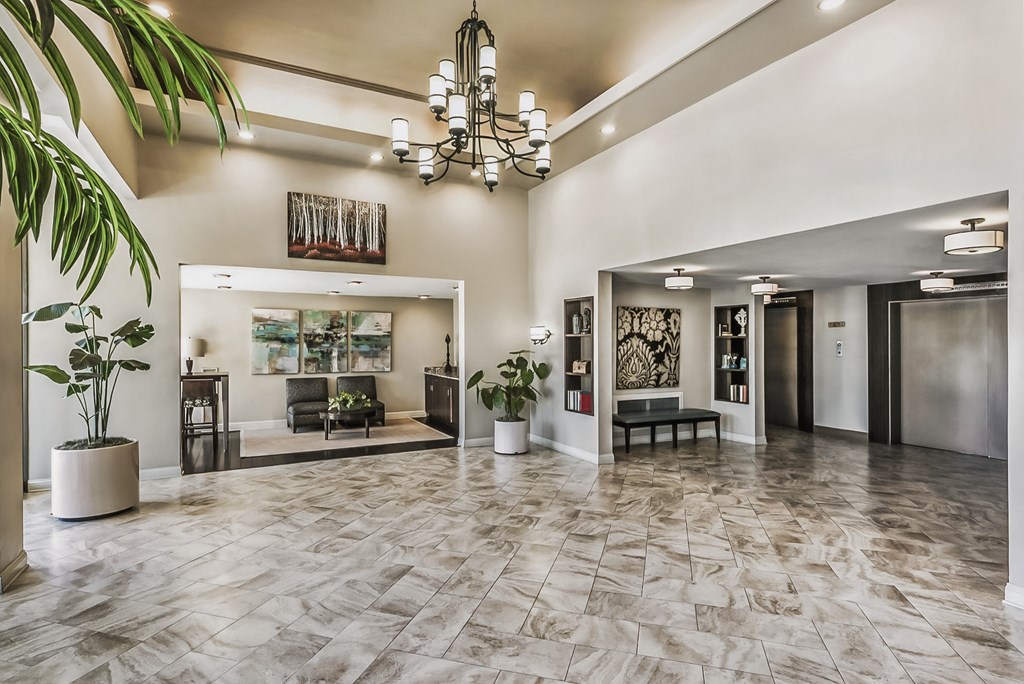 a lobby with a chandelier and a seating area