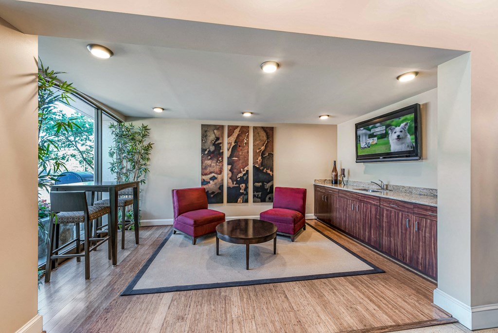 a living room with a kitchen and a table with chairs