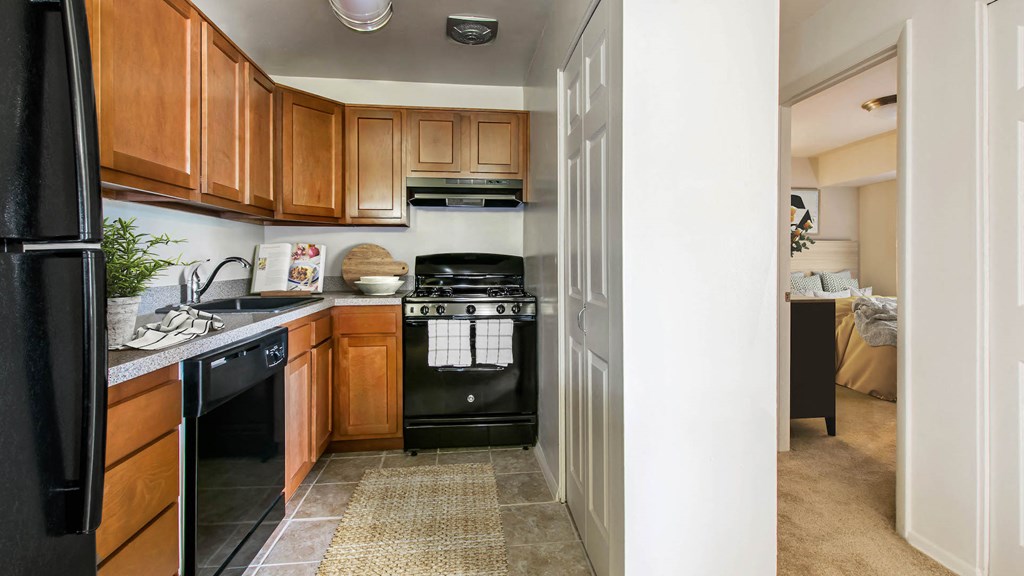a kitchen with black appliances and wooden cabinets