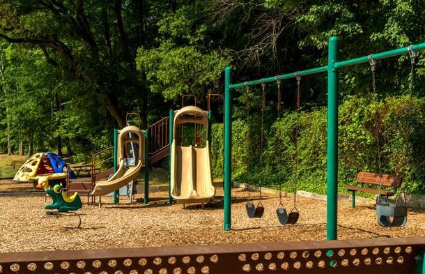 a playground with a swing set and slides