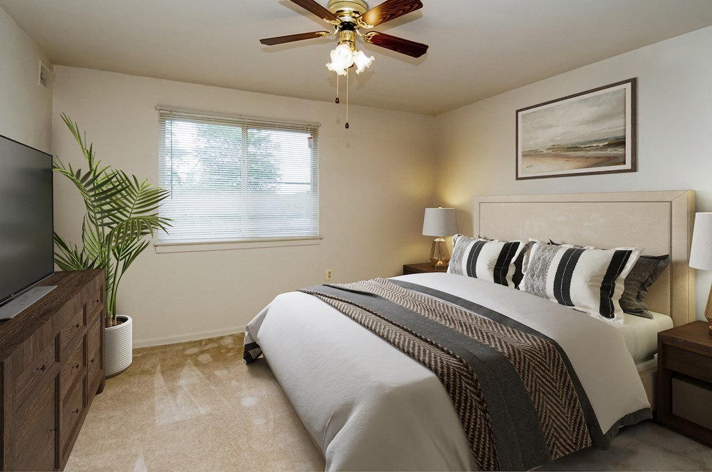 a bedroom with a bed and a ceiling fan