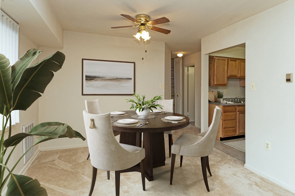 a dining room with a table and chairs and a ceiling fan