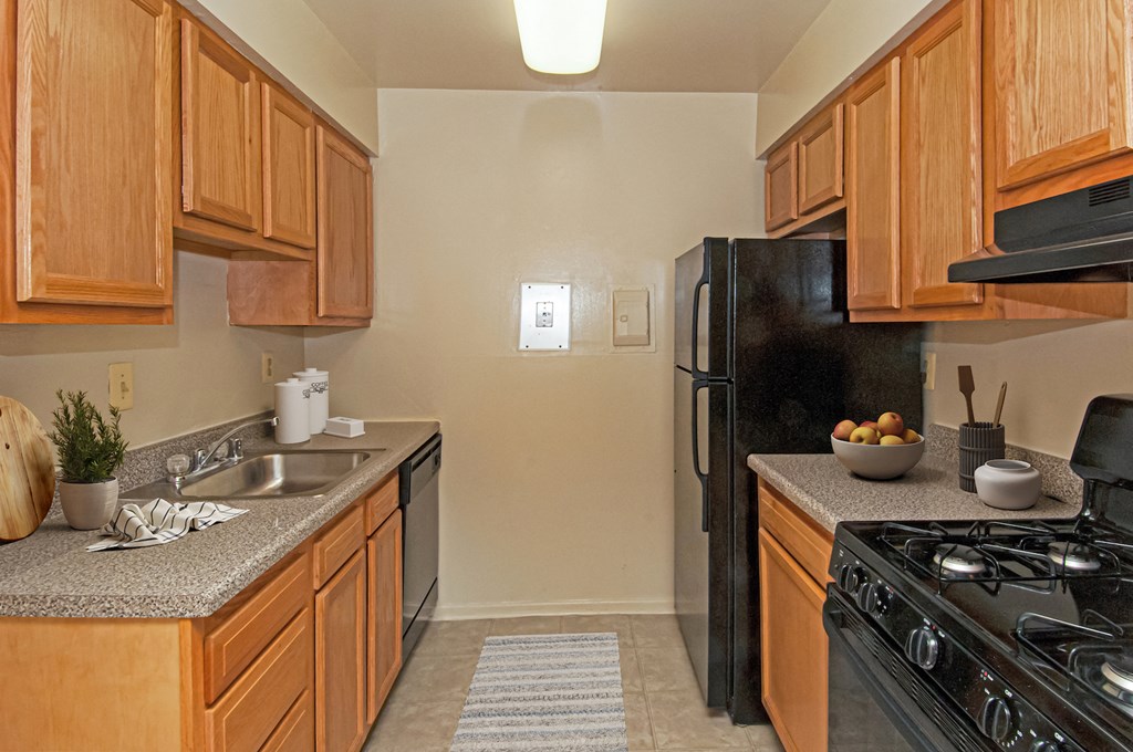 a kitchen with black appliances and wooden cabinets