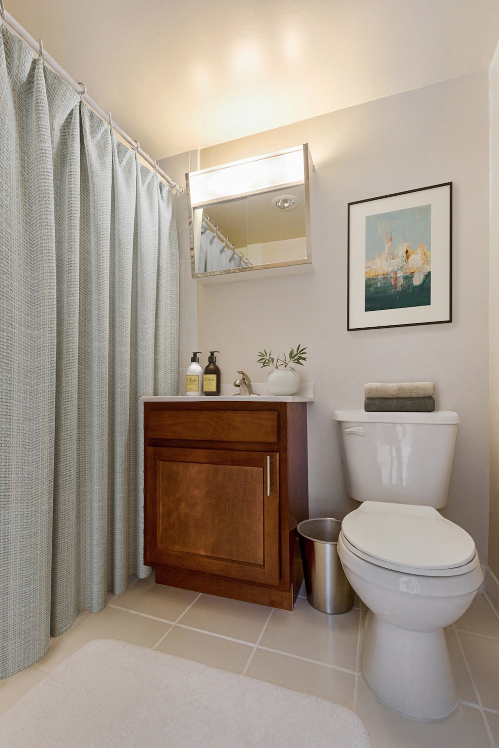 a bathroom with a toilet and a sink and a shower