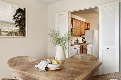 a kitchen and dining room with a wooden table and chairs