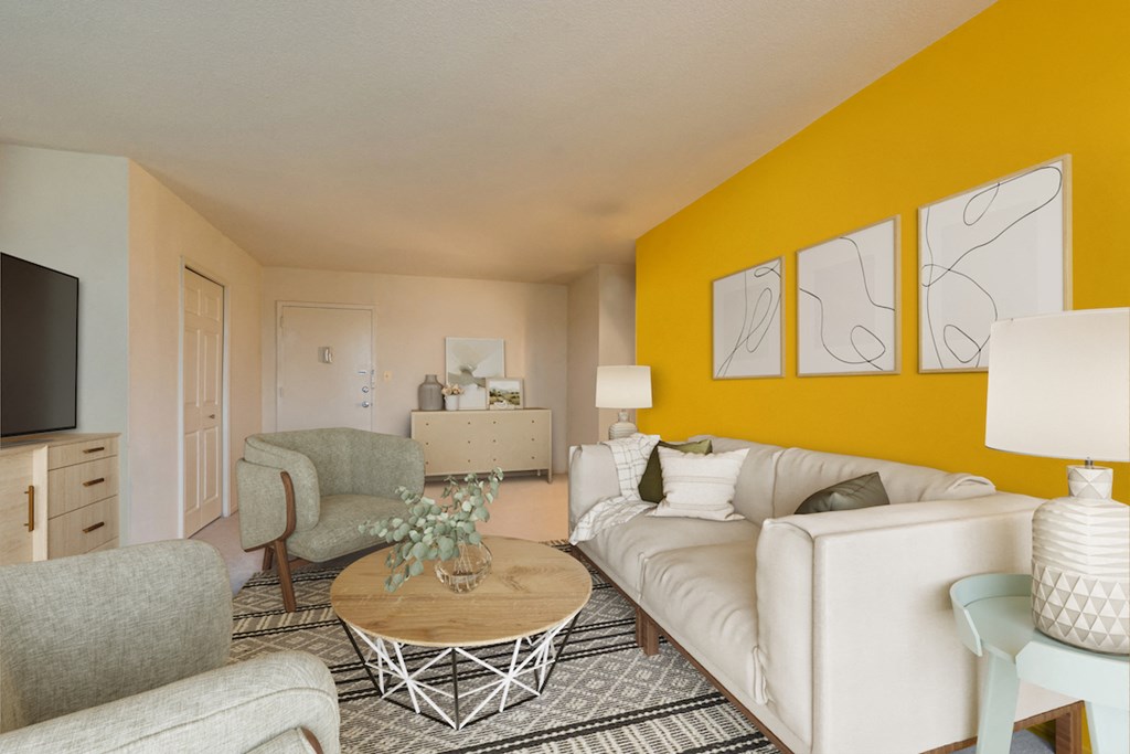 a living room with a yellow accent wall and white furniture