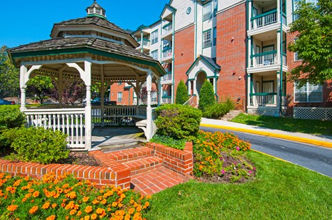 a gazebo in front of an apartment building