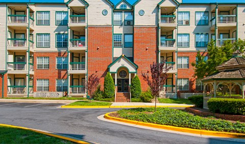 an empty street in front of an apartment building