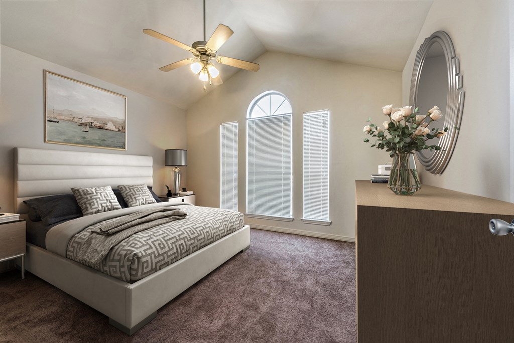 a bedroom with a bed and a large window