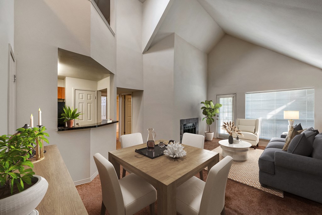 a living room and dining room with a table and chairs