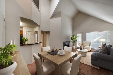 a living room and dining room with a table and chairs