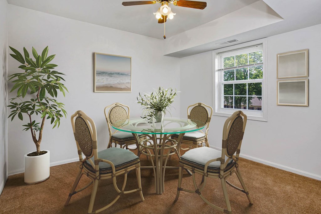 a dining room with a table and chairs