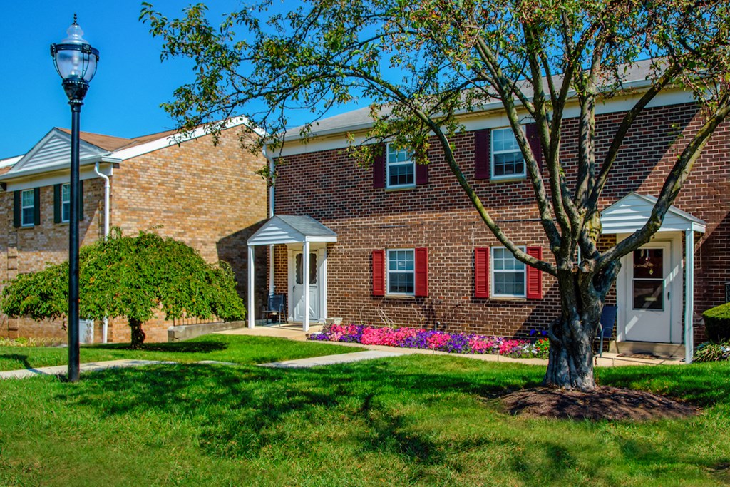 a brick building with a tree in front of it