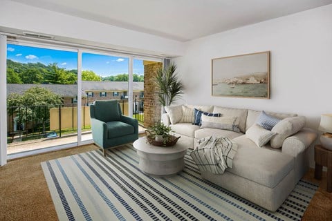 a living room with a white couch and a blue and white striped rug