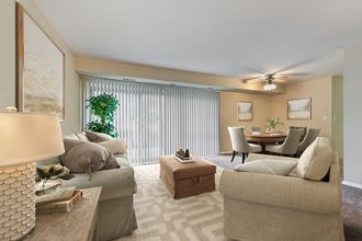 a living room with couches and chairs and a dining room table