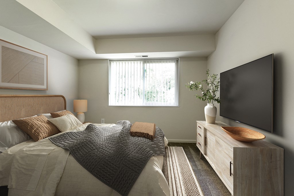 a bedroom with a bed and a television