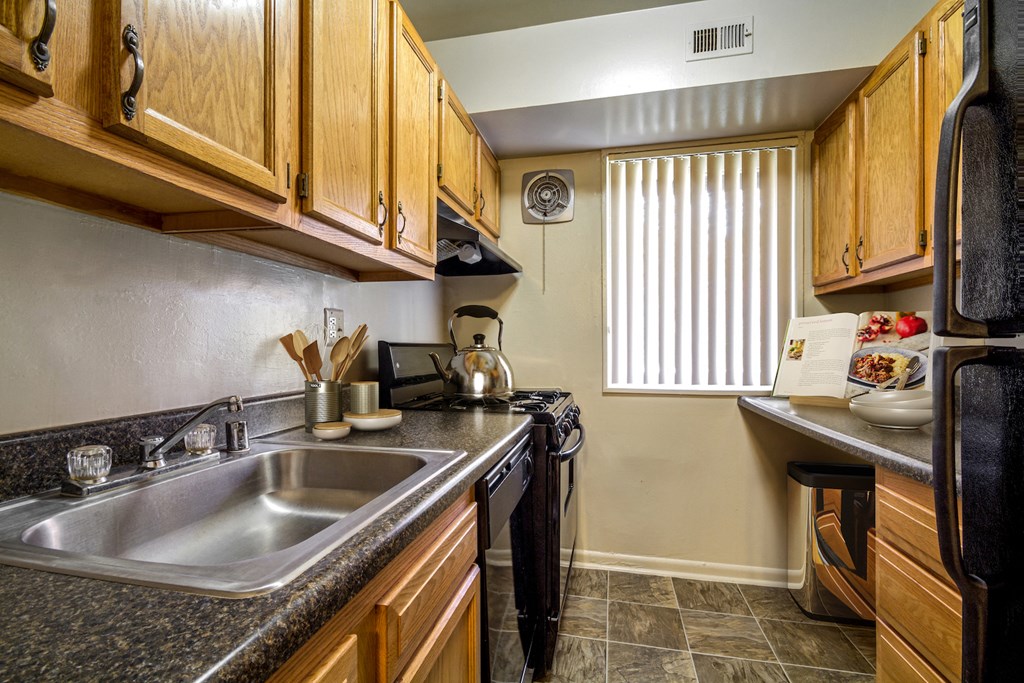 a kitchen with a sink and a stove and a window