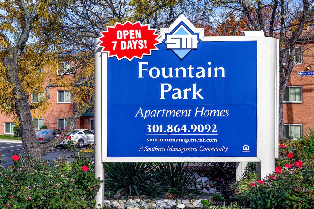a sign for fountain park apartment homes in front of a building