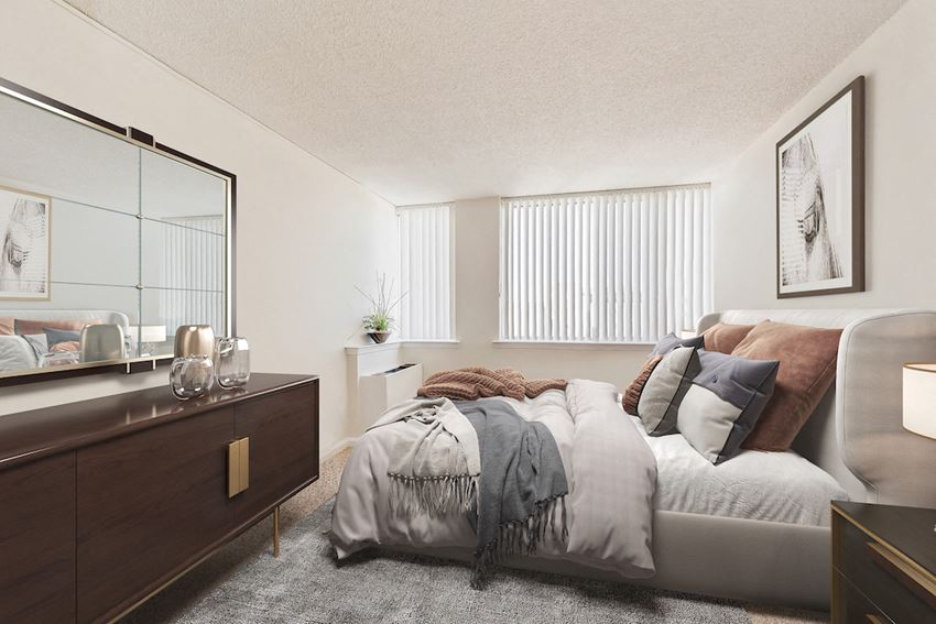 a bedroom with a bed and a dresser and a mirror