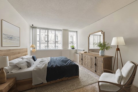 a bedroom with a bed and a dresser and a window