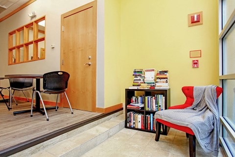 a dining room with a table and chairs and a book shelf with books