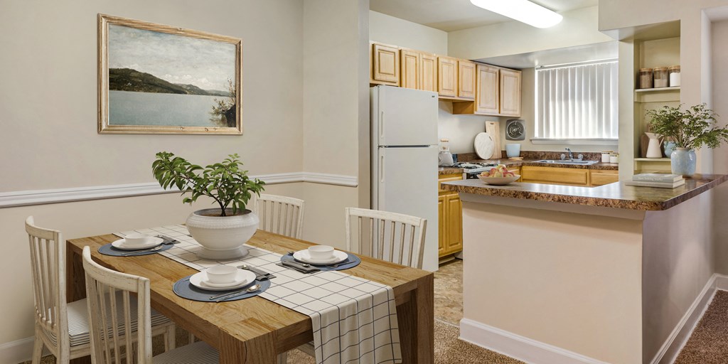 a dining room and kitchen with a table and chairs