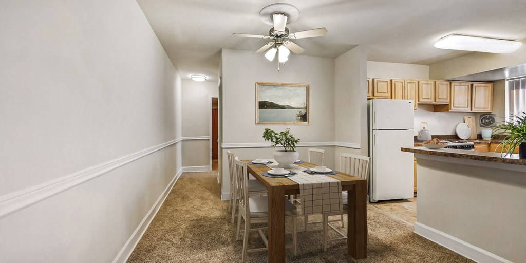 a dining room and kitchen with a table and chairs
